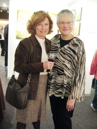 hansons Customer Barbara Apking sips red wine while chatting with Diane Hanson, proprietor of Hanson's Fine Arts and Craft in Bearden