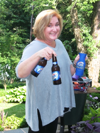 beer-lover Hostess Mary Ellen Brewington pulls some of her favorite beverages from a cooler to serve some guests.