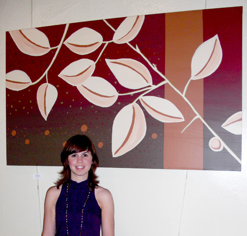 julie3 Moxley Carmichael graphic designer, Julie Bernal, stands in front of one of her paintings currently on display at Tomato Head on Market Square.