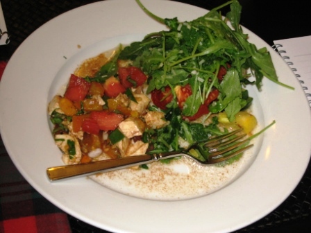 finished-plate Chopped Caprese salad on the left, a mound of arugula seasoned with sea salt and lemon sits attop the halibut and tomato, and fresh summer squash from the Farmers' Market is a side dish.