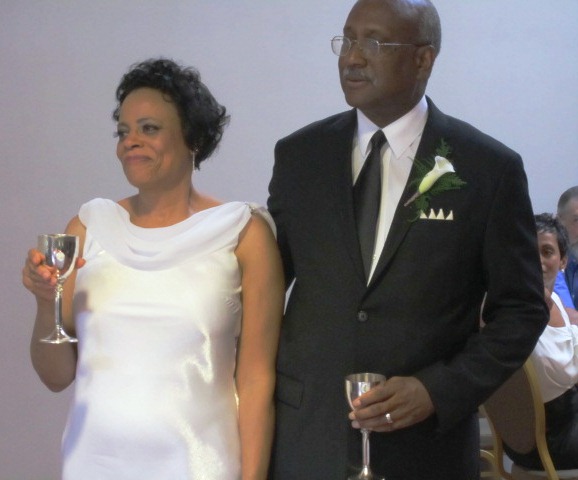 The couple listening to a toast by Janice Robinson.