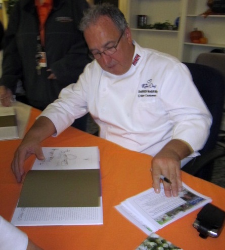 chef-signs-book Chef Darren McGrady, during visit to Knoxville, signs his cookbook, Eating Royally.