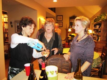 Jane serves wine to Monique Anderson, center, and Jan Wade.