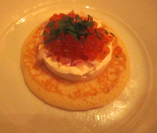 caviar-appetizer Buckwheat blini and red caviar with chopped egg, minced red onions and sour cream