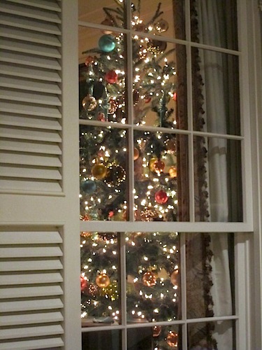 tree-from-outside Here's a shot of the tree from outside on the porch. Festive.