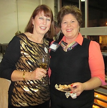 2-ladies One of the hosts, Elizabeth Offringer, left, greets a guest.