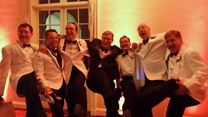 No threat to the Rockettes! Enjoying themselves in a kick-line at the Opera Ball were, from left, Douglas Clark, Dino Cartwright, Mark Hill, Orchestra Leader Brad Walker, Peter Acly, Alan Carmichael and Dan Chips. Photo by Pamela Chips. Rockettes not