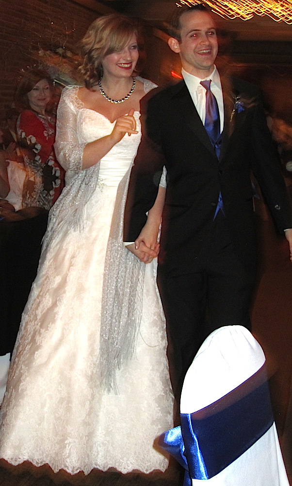 The married couple entering their wedding reception