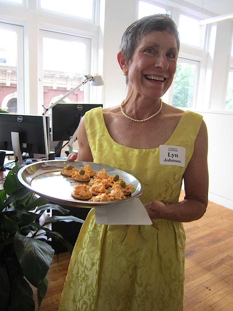 Host Lyn Johnson passed 1960s era hors d'oeuvres.
