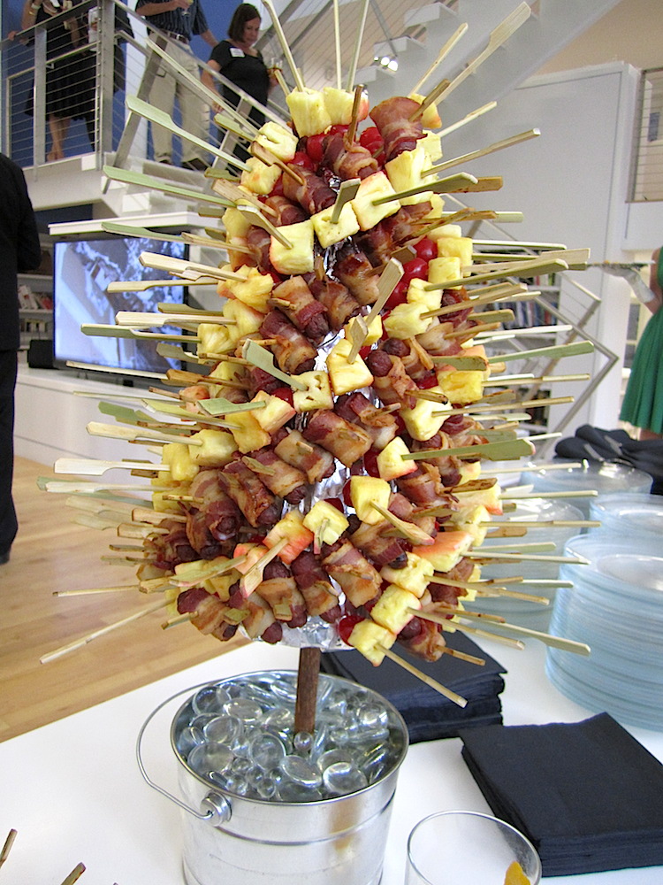 How about this classic presentation? A tree of bacon wrapped cocktail weiners, pineapple and rum soaked cherry skewers.