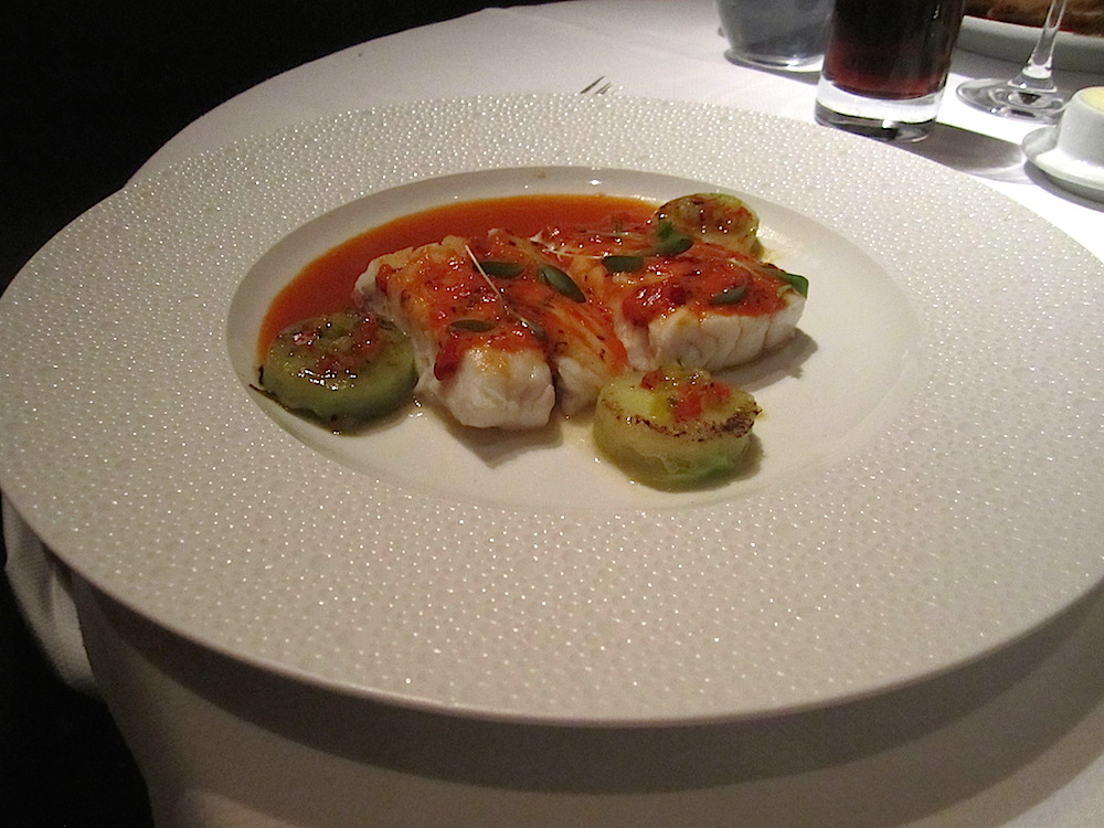 Baked snapper with charred green tomatoes and Baja style shrimp sauce.