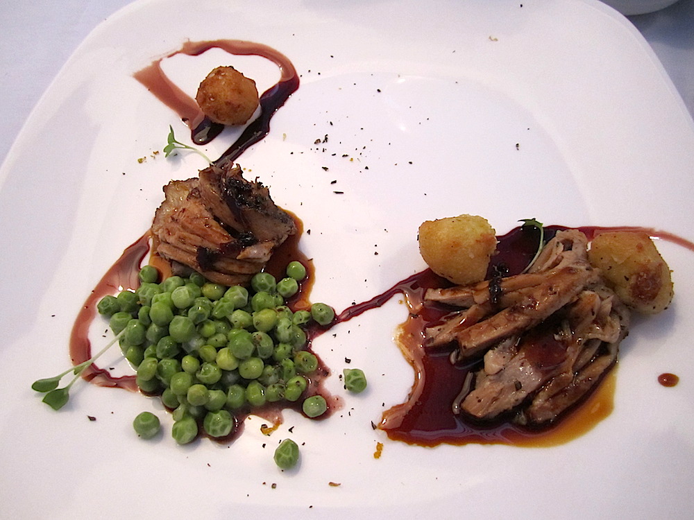 Here's veal rib with potato Dauphine and sweet peas. Over the veal is a morel and mushroom reduction.