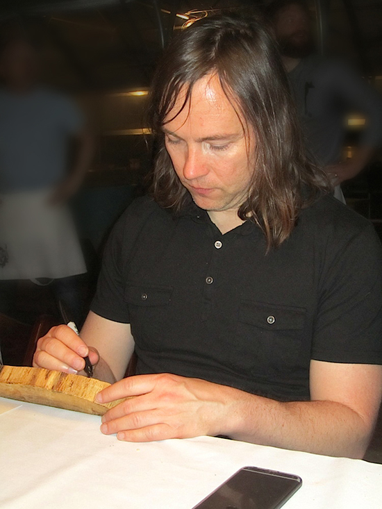 It is customary to sign the back of the wooden chargers at Trust Fall dinners.