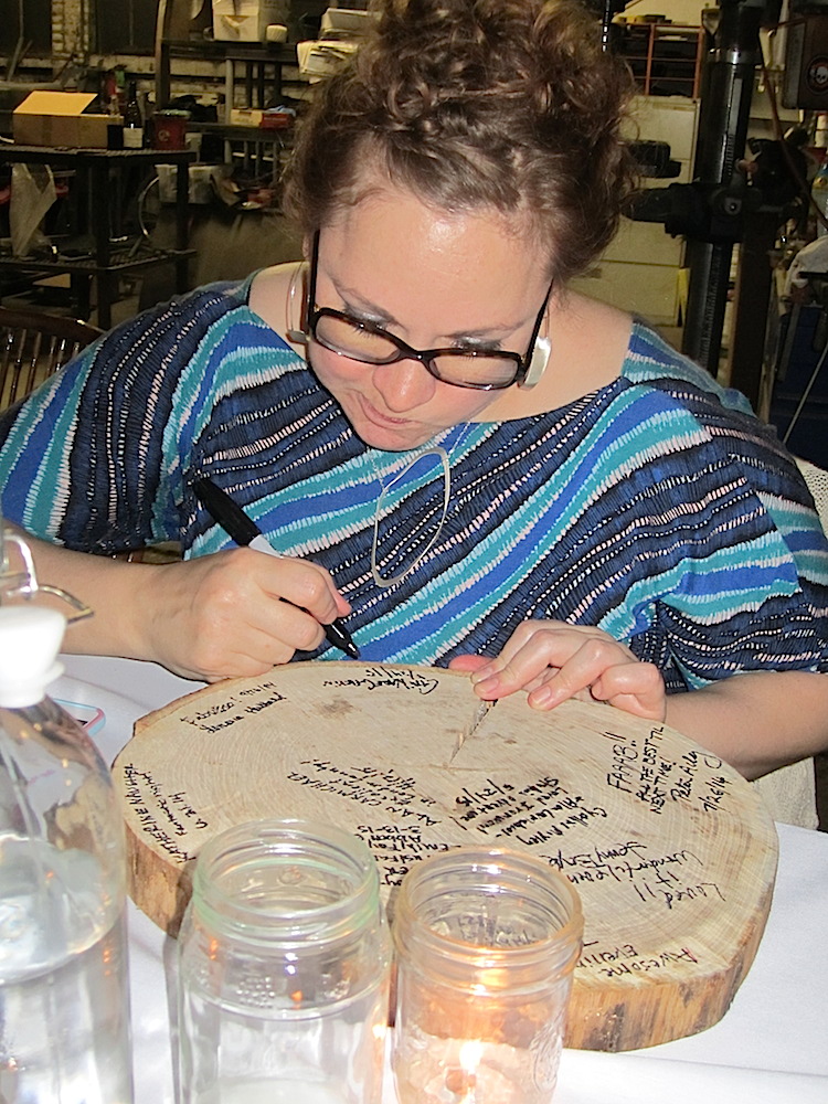 It's traditional to sign the chargers at the conclusion of these meals. Here's Cari Gervin doing that.