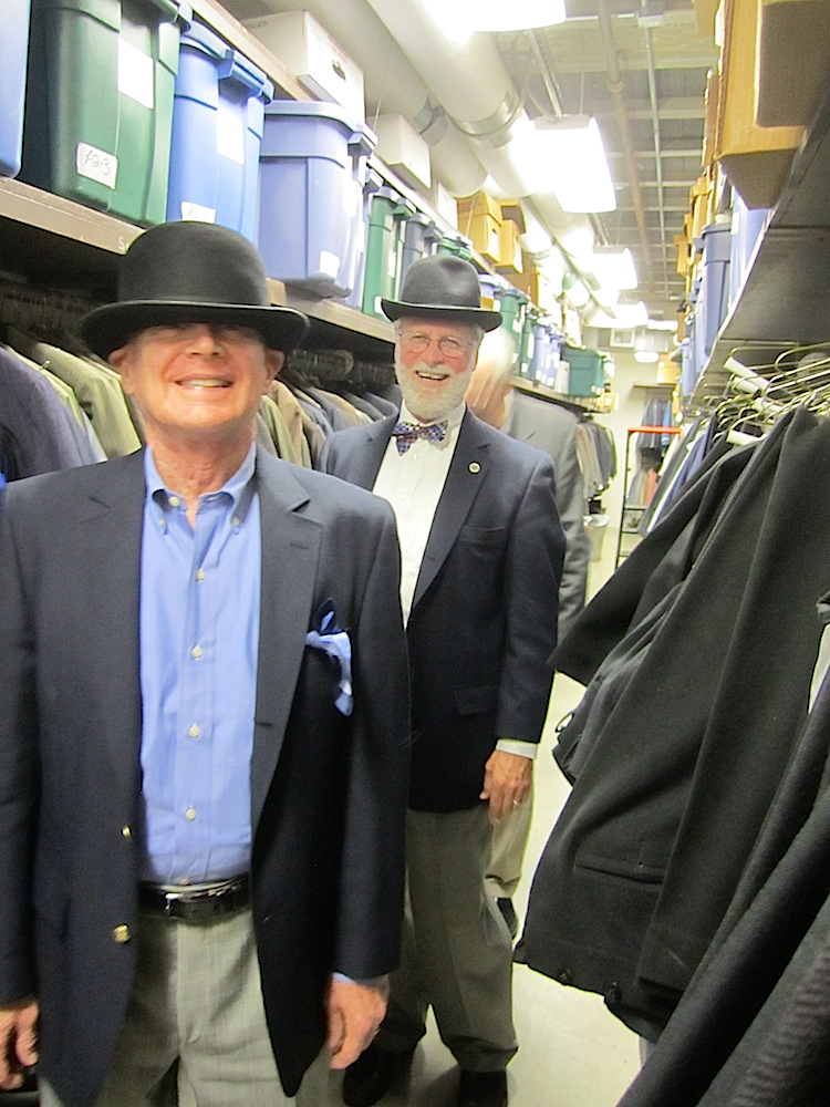 Jon Roach, left, and Finbarr Saunders trying on hats in the costume shop backstage at the Clarence Brown Theatre.