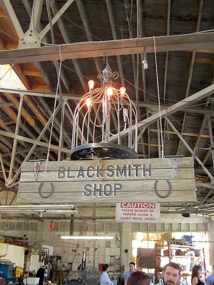 How often do you get to eat a gourmet meal in a working blacksmith shop. Love the chandelier.