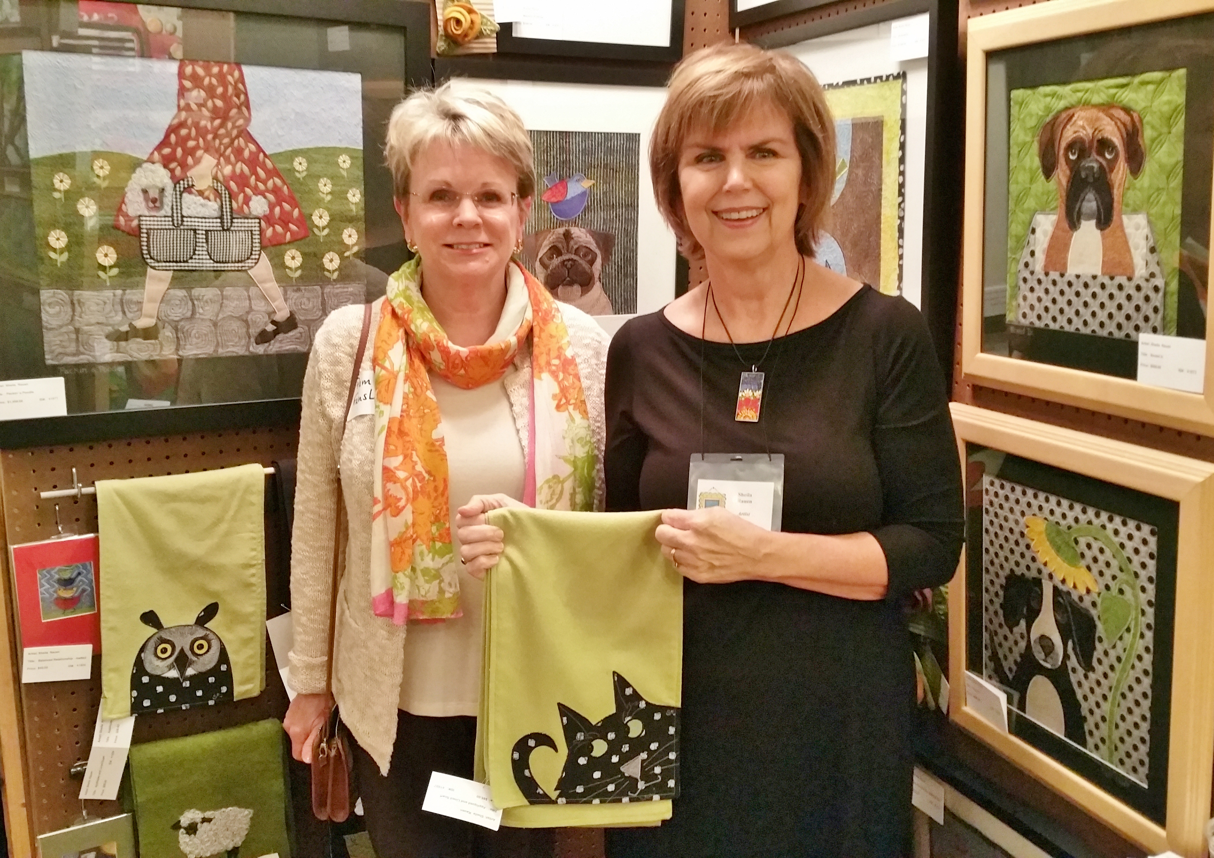 Pam Fansler, left, of First Tennessee Bank purchased this adorable scarf from Sheila Rauen. Fansler is on the Covenant Health board of directors and is an Artisan Circle sponsor of Artsclamation!