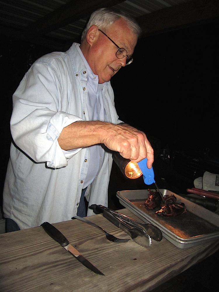Then Sam went back to the task at hand -- the food. Here he's checking the temperature of some meat he just removed from the grill.