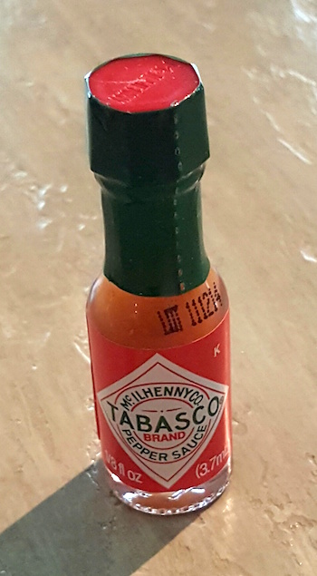 This little bottled contains 1/8-th of an ounce of Tabasco. Perfect!