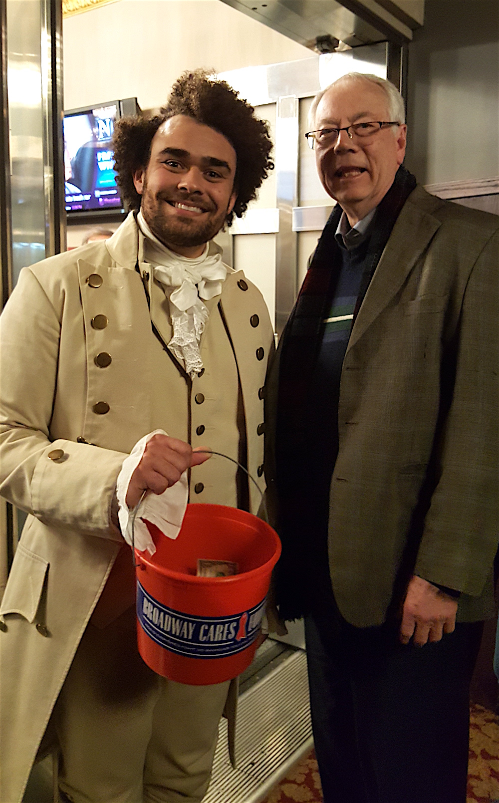Alan puts money in the bucket of "James Madison," -- actually actor Andrew Chappelle -- following the blow-you-away performance of the play, "Hamilton." Every year for a week, theater folks collect money for a charity called Broadway Cares, which helps people affected by AIDS.