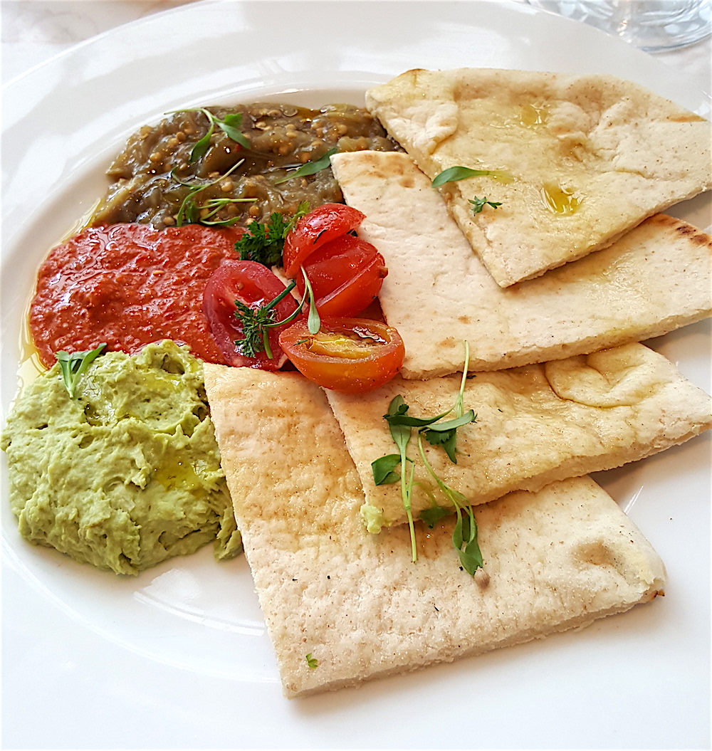 For starters, we shared a mezze plate which contained pita bread and three dips: mashed fava beans, roasted red pepper with walnuts and roasted eggplant.