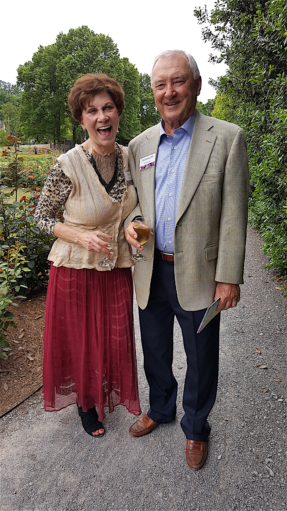 Jane and Kenneth Creed strolling through the gardens during the cocktail hour.