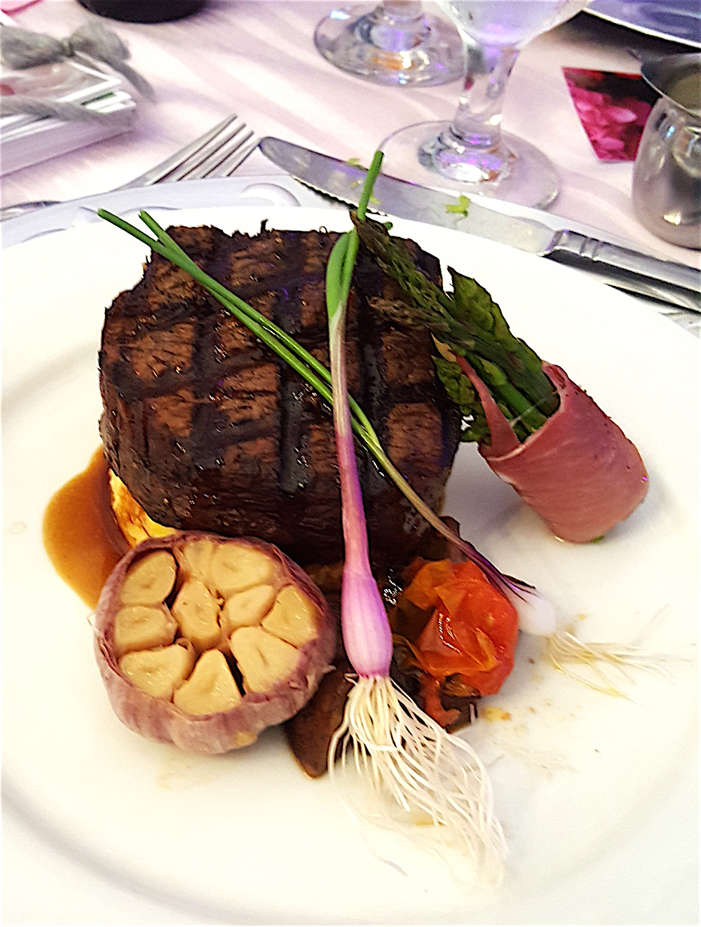 What an entree! Herb and shallot grilled filet of beef served with Shelton Farms smoked gouda polenta cake, prosciutto-wrapped asparagus and a Monterey wild mushroom and heirloom tomato sauce.