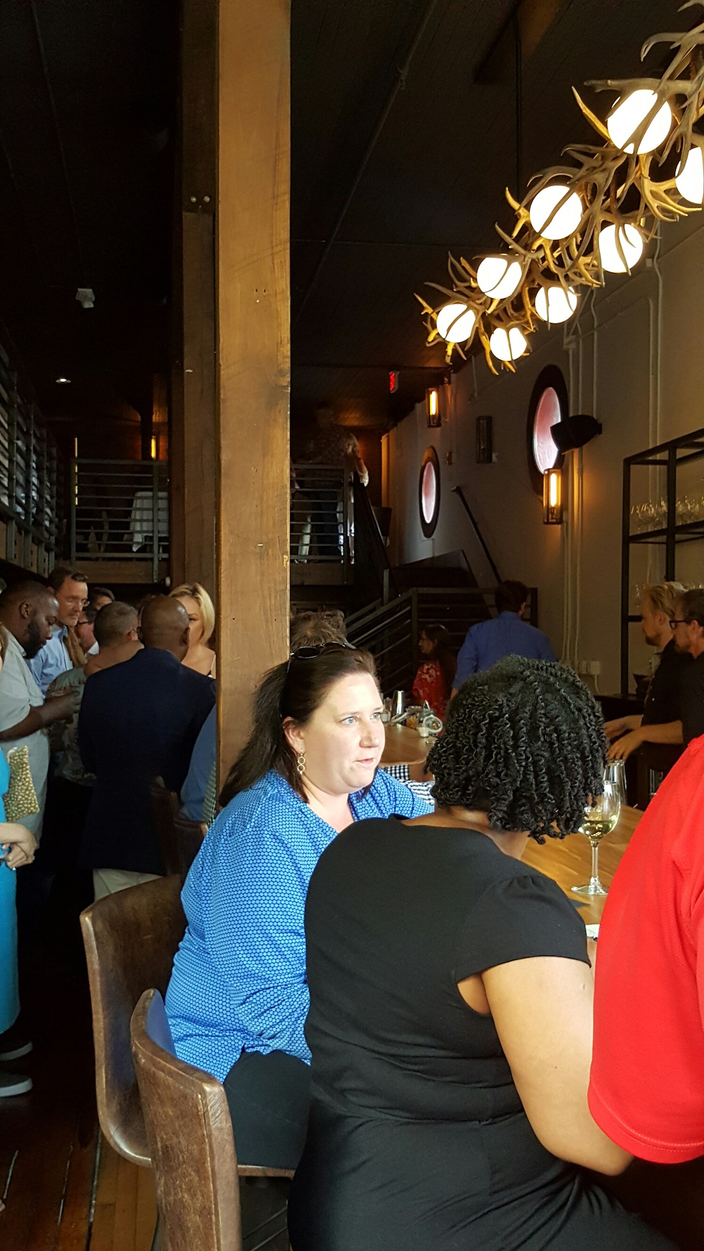 Here's the view when you enter the front door. Notice the light fixture above the bar made of antlers That's my friend Judy Holder in the blue.