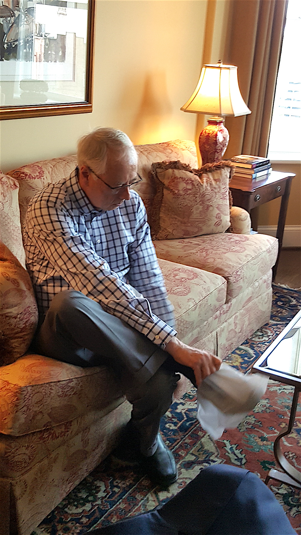 Alan Carmichael puts on his booties in preparation for our tour of a luxury condo in The Elliot.
