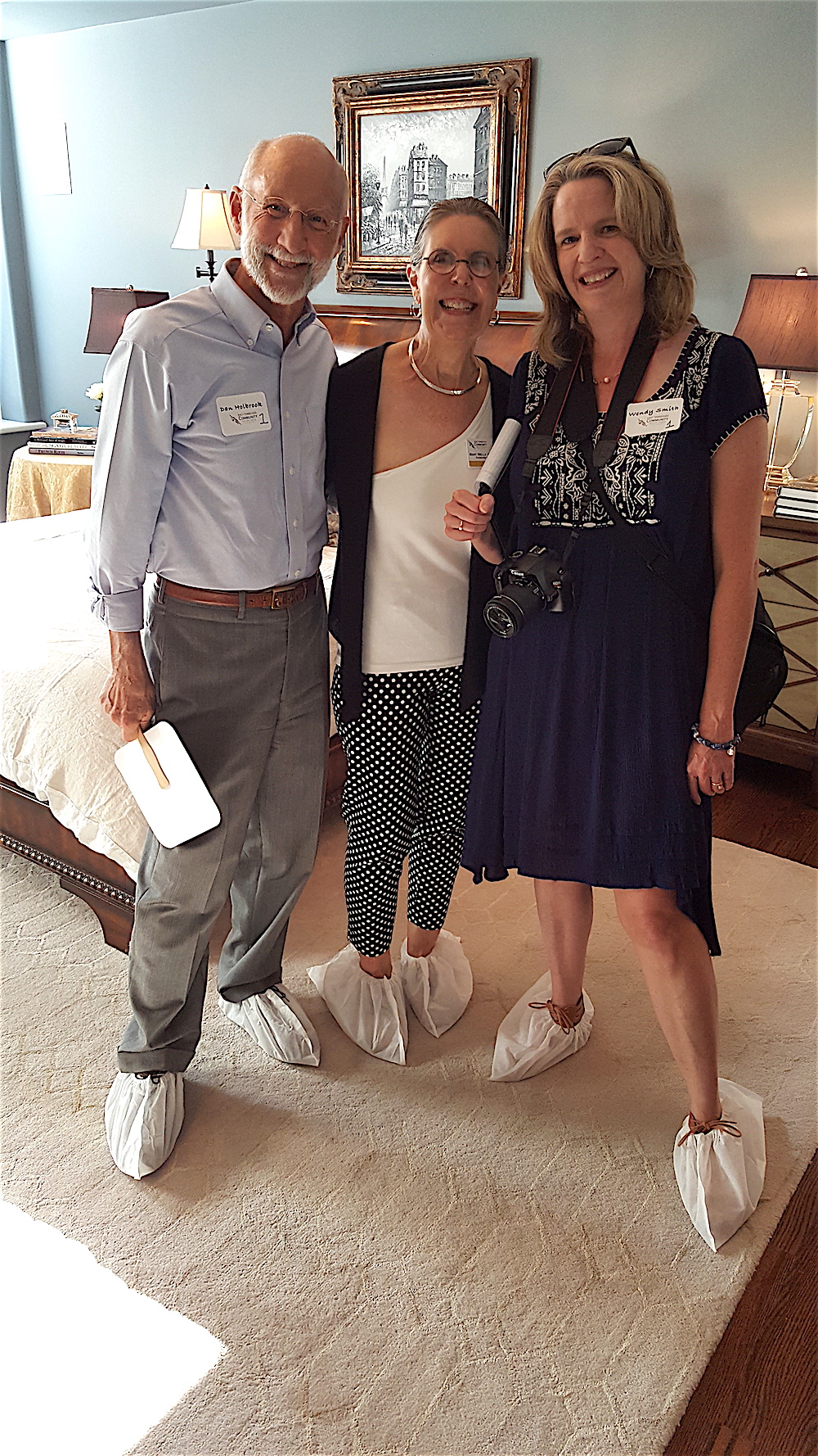 Dan and Mary Holbrook with Wendy Smith, right, of the Shopper News. They were photographed in the master bedroom.
