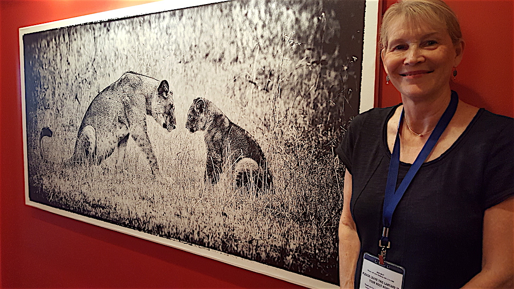 Gayle Buston, who husband's photography fills the walls, showed everyone around.