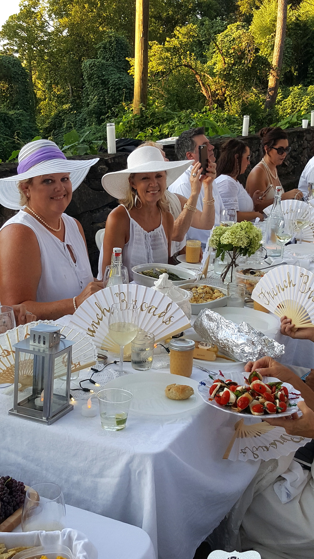 That's our buddy Vicki Baumgartner in the white hat. She was instrumental in securing the Botanical Garden as a location. Love the fans at her table that say, "French Broads!"
