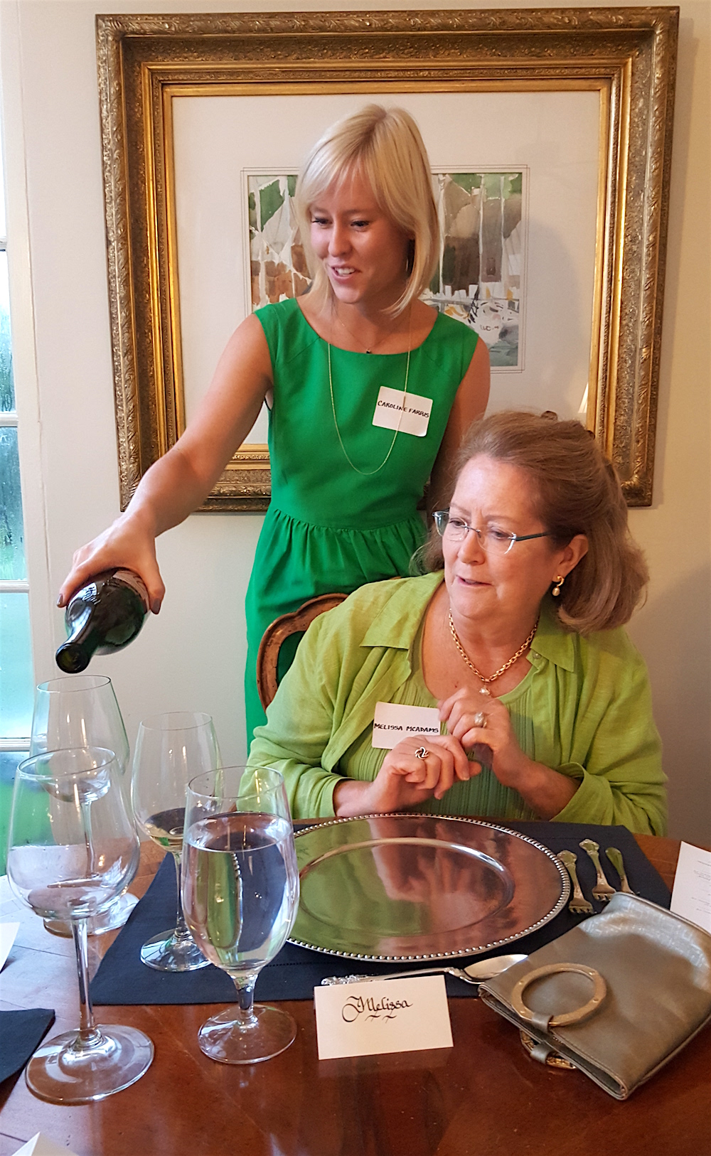 Caroline providing Melissa with wine for the next course.