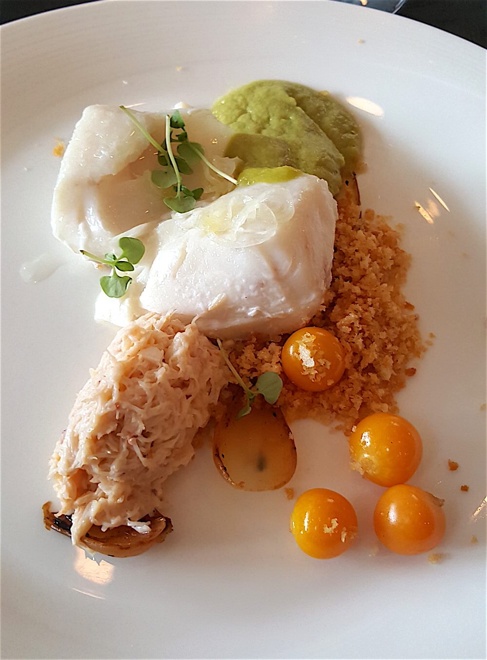 Those of us (like me) who chose fish, got poached halibut with peekytoe crab, a duckfat and allium puree and ground cherries. (Those things that look like little tomatoes? They are the ground cherries. I assume, meaning they are grown on low bushes rather than traditional cherry trees. They are sweet-tart and delicious.