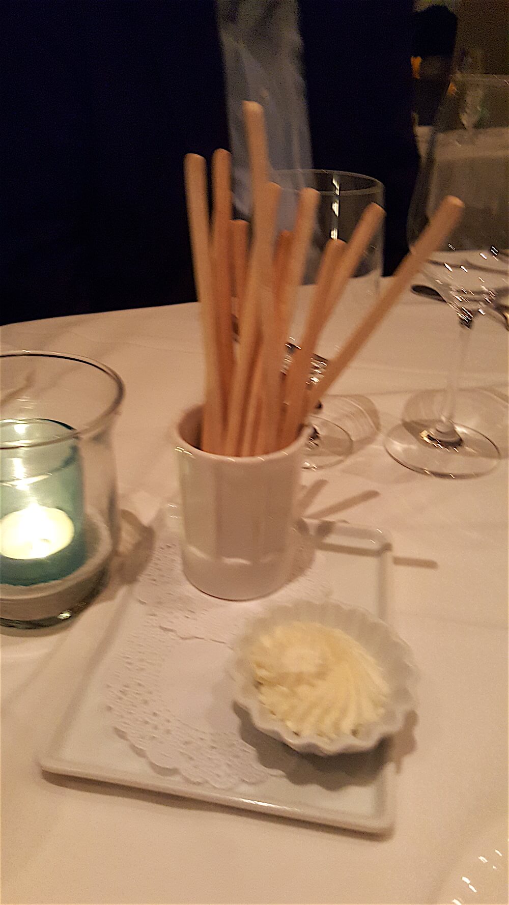 Breadsticks with truffle butter are waiting for you at the table.