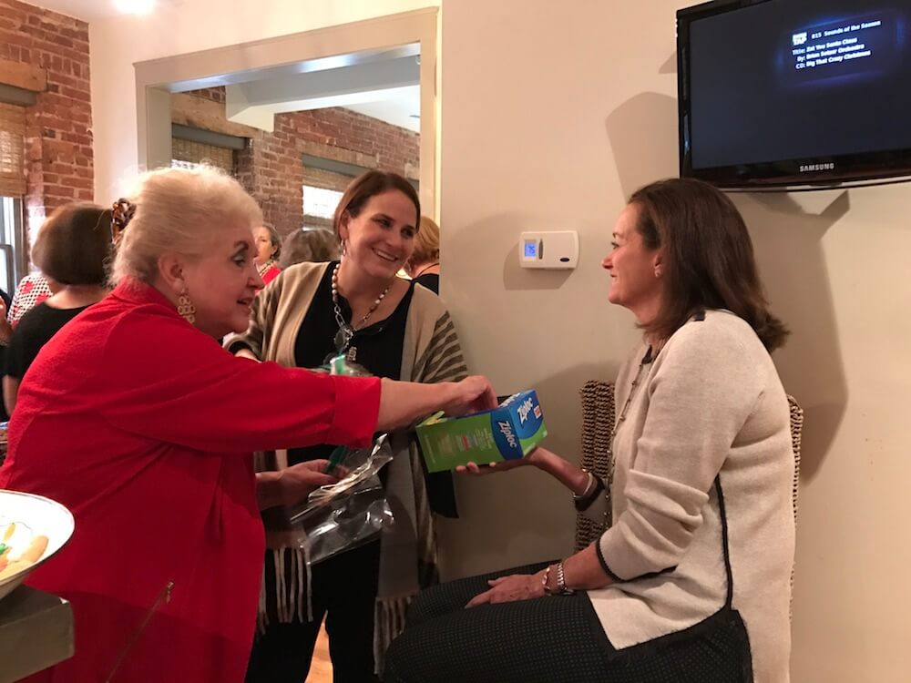 Dawn and Janet grabbing ziplock bags from Mintha.