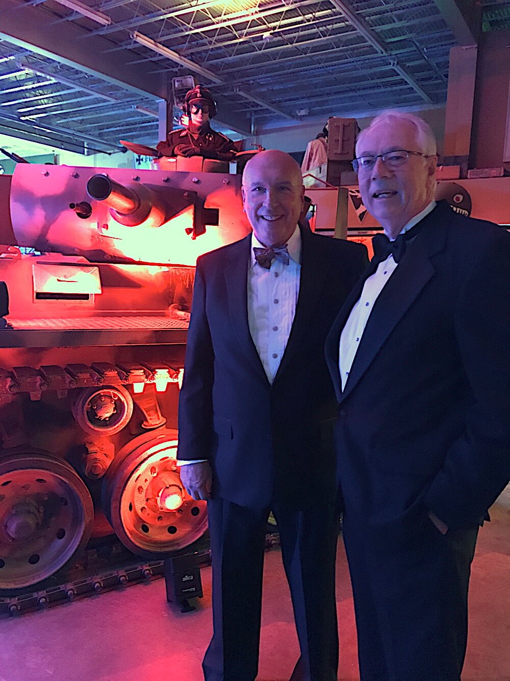 Richard Bryan, left, and Alan Carmichael pose in front of one of the tanks in the "party bunker."