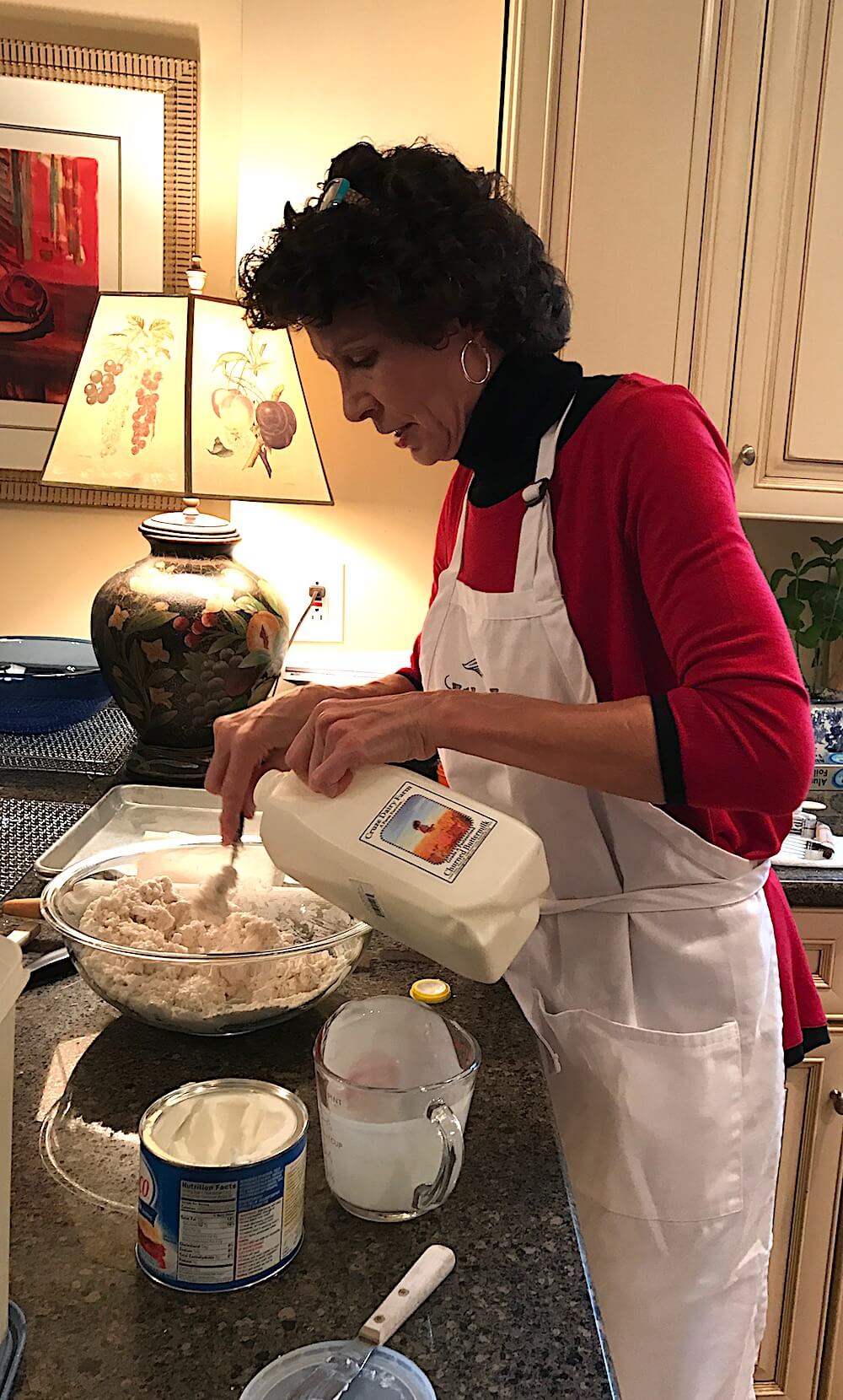 Add the buttermilk, but don't stir it with a spoon. Instead, use a fork to moisten the flour mixture by adding the buttermilk a little at a time. Don't overwork it or you will make it tough. When all the dough is wet and there is no dry flour at the bottom of the bowl, you are finished with this step.