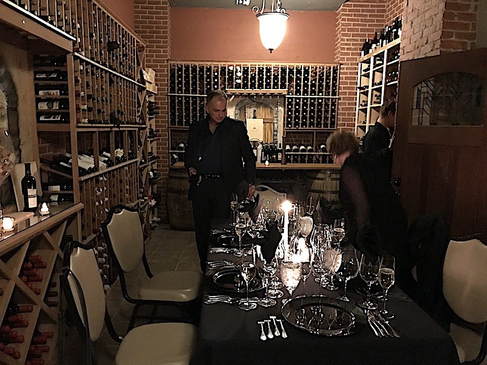 Friends Tim Young and Monique Anderson checking out the charming table set up for dinner in the wine cellar of Cherokee Country Club.