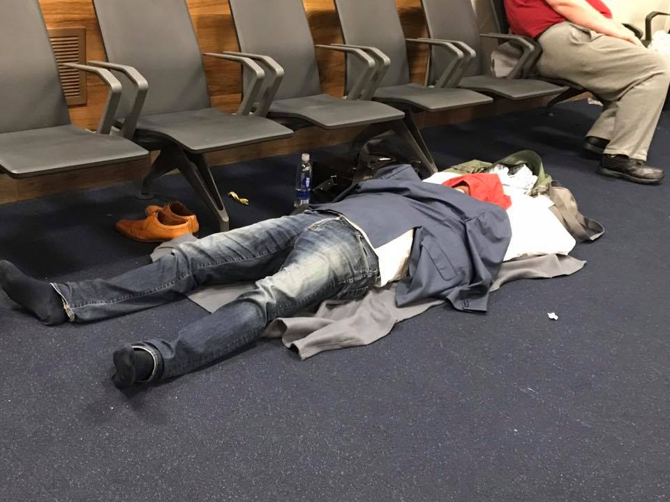 A passenger delayed overnight in the Atlanta airport sleeps on the floor. (Cynthia Moxley photo)