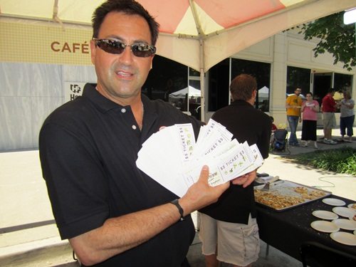 jim-and-tickets Jim Klonaris of Cafe 4 displays just some of the tickets he had collected. The crowd was huge.