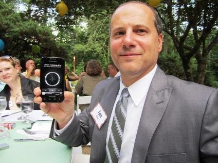 tom-and-anti-mosquito1 Our friend Tom Catani of U.S. Cellular, turns on his anti-mosquito app! It emits a sound that keeps them away! (Tom has all the good apps.)