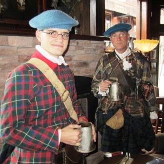 hoisting-a-stein Joseph Gamble, left, and Charlie Rhodarmer, manager of the Sequoyah Birthplace Museum, came in character to the ribbon cutting last week.