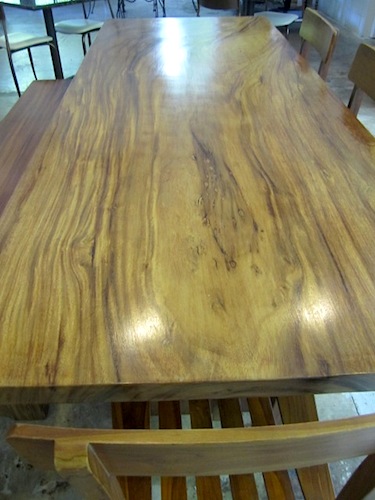 one-slab-table The couple shipped by container ship many furniture pieces they had collected over the years including this beautiful table made from a single huge slab of a tree.
