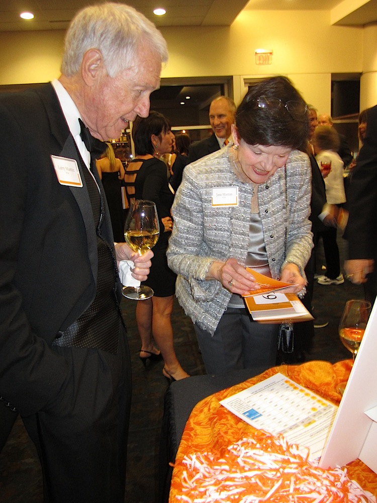Larry and Jane Martin discuss a silent auction bid.