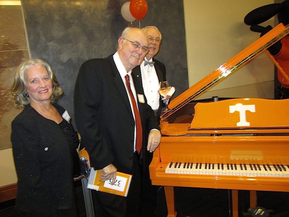 Melanie and Vince Staten with Alan Carmichael, admiring a special piano.