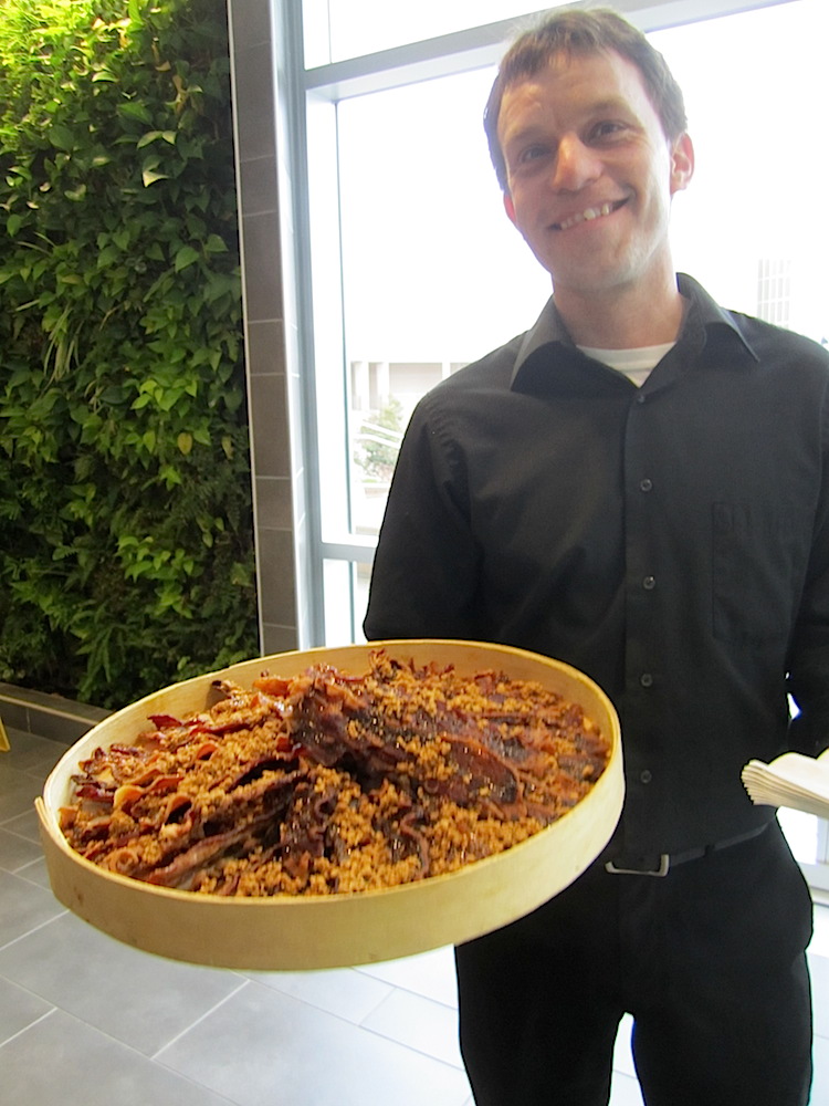 Kim Donahue passing candied bacon -- the signature dish of premier caterer Holly Hambright.