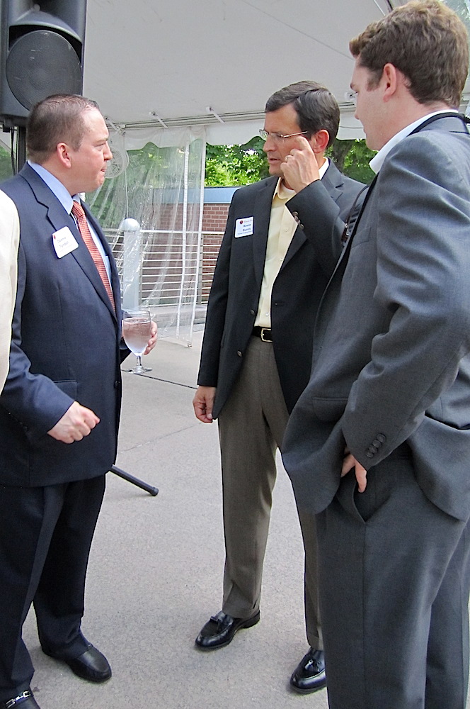 Coach Tyndall chats with Kevin Burris of Premier Surgical, center, and his son, Charles Burris, another former Moxley Carmichael intern.
