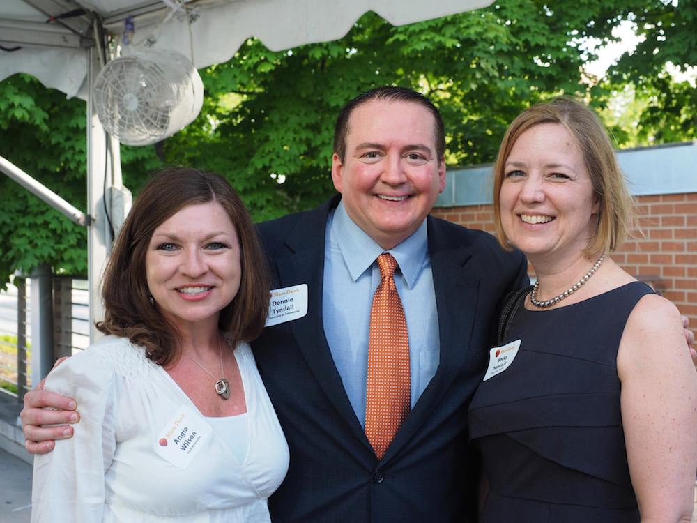 Angie Wilson, left, of Visit Knoxville, and Becky Hancock of the Tennessee Theatre with Coach Tyndall. (Photo by Gary Heatherly)