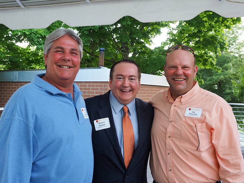 Sheriff J.J. Jones, left, and Assistant Chief Deputy Lee Tramel with the coach. (Photo by Gary Heatherly)